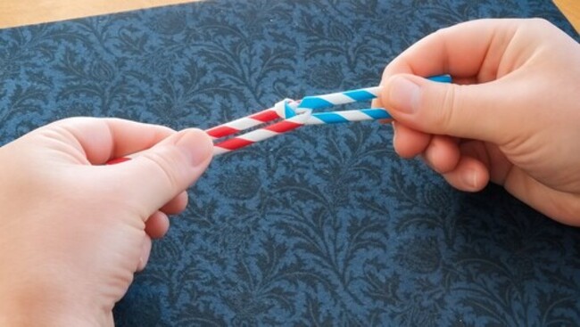 Two straws tied together in a seemingly impossible knot.