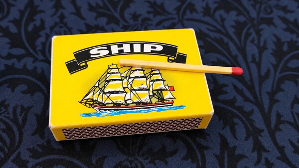 Match placed on top of a matchbox