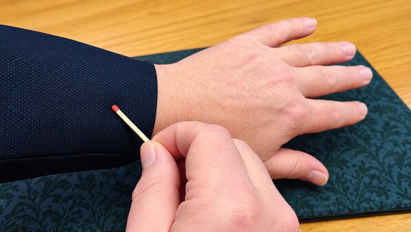 Rubbing a match on your sleeve.