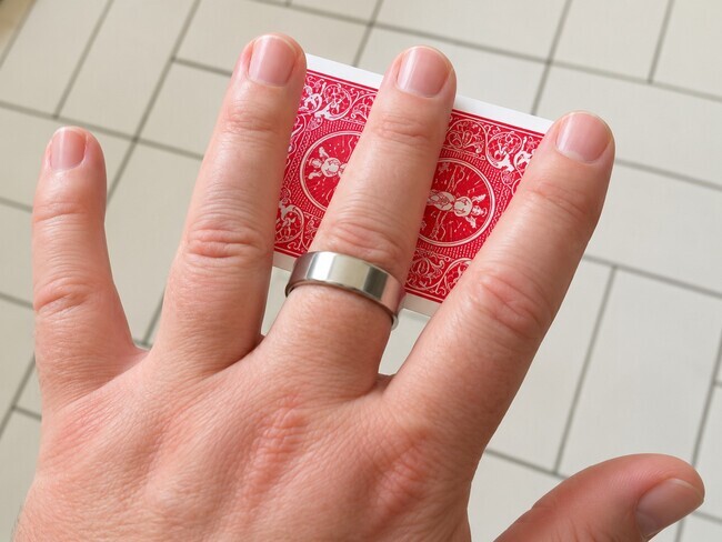 A card appears to float up under a magician's hand.
