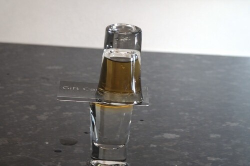 Water and whisky exchanging places between two stacked glasses