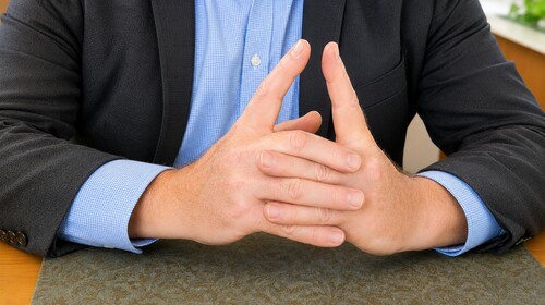 Spectator holding index fingers upright and slightly apart