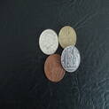 Magic coins in various colors and sizes, ready to perform an exciting coin trick..