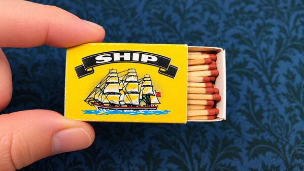 Matchbox opened slightly to show loose-looking matches