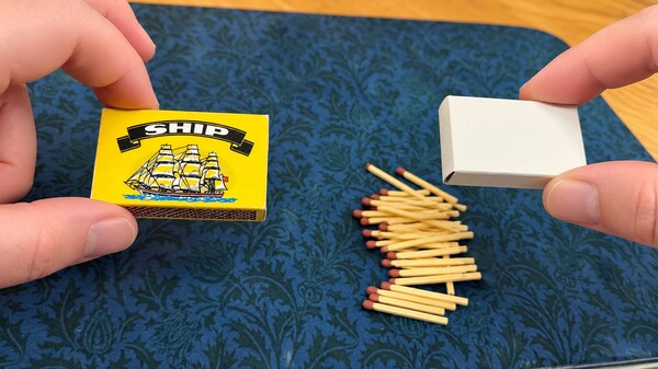 Sides of matchbox squeezed to release the matches