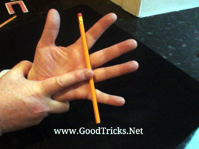 Image showing the secret positioning of other hand to hold the pencil in place.