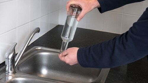 Placing disc on bottle