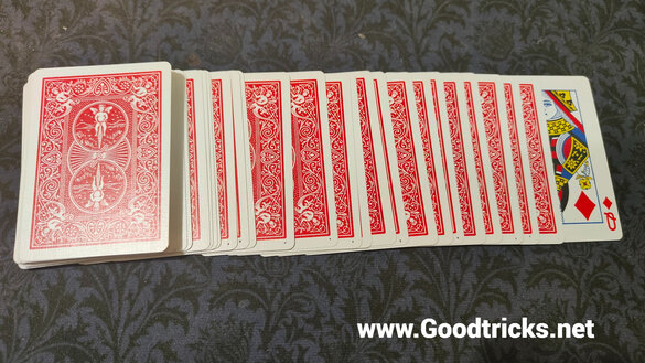 Deck of playing cards with bottom card turned over.