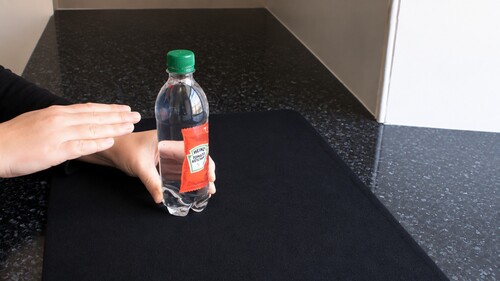 The sachet hovering around the middle of the water-filled bottle