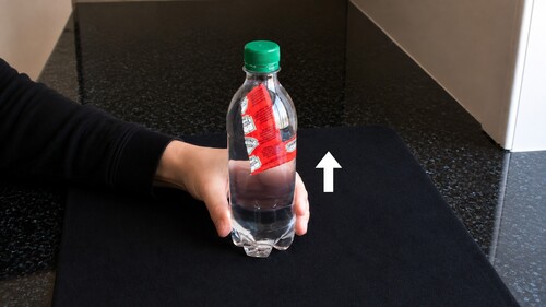 The condiment sachet rising back towards the top of the bottle