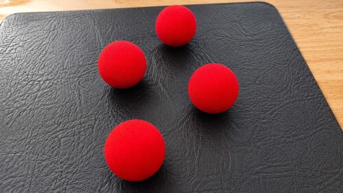 Four sponge balls ready for close-up magic
