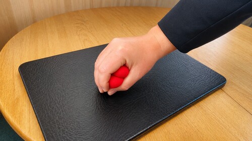 Two sponge balls being pinched together and compressed as one