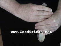 Hold end of spoon with hand containing the hidden coin.