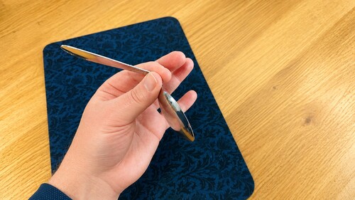 An ordinary teaspoon being wiggled to look flexible