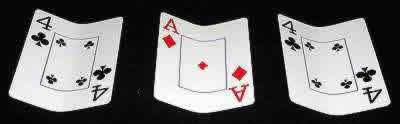 Three cards set up for three card monte hustle trick.
