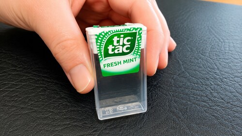 Coin concealed behind the Tic Tac label