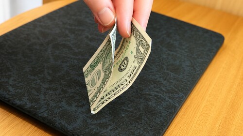 Dollar bill folded in half