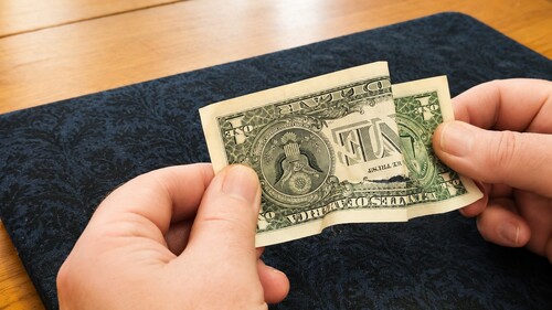 Folded dollar bill being opened for the restoration