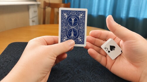 The unfolded playing card displayed while the duplicate remains hidden