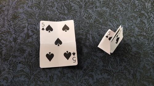 One card unfolded while the matching folded duplicate is concealed