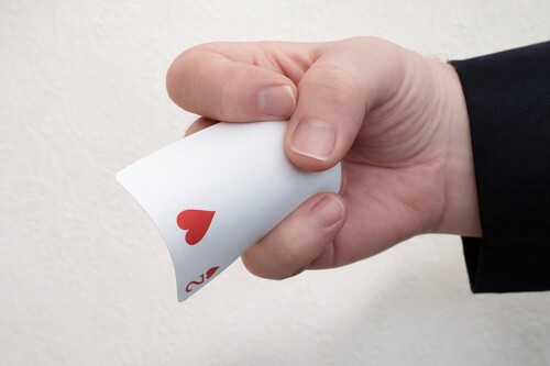 Thumb and middle fingers preparing the concealed card to reappear