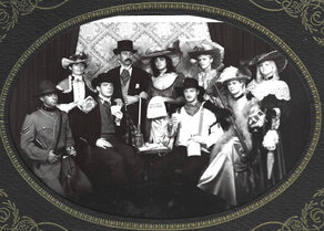 Wild west characters posing for a photo in a typical western style setting.