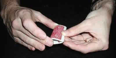 Putting a lengthwise S bend in the card for the three card monte trick.